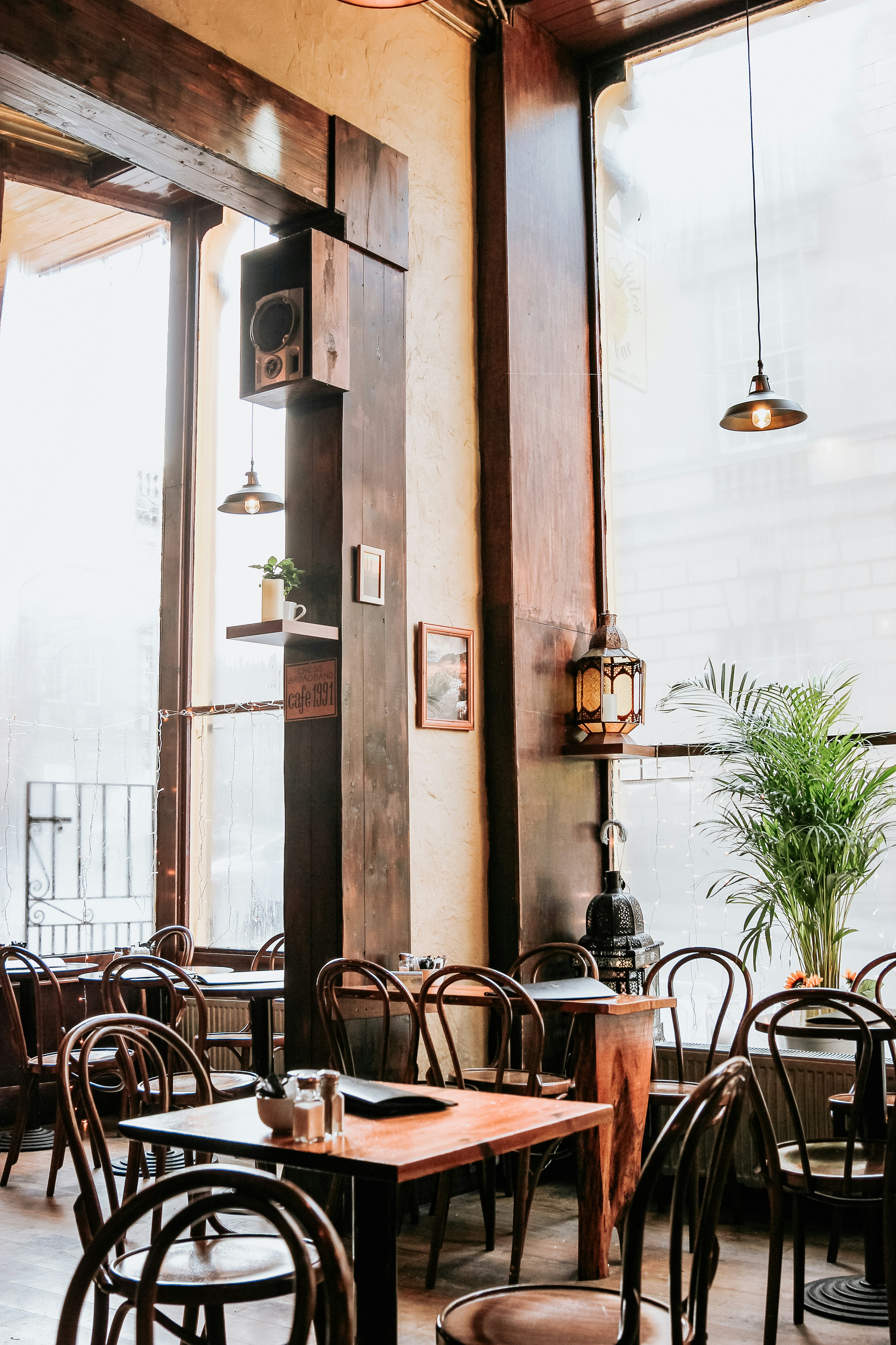 A warmly lit restaurant interior with tables set for dining — representing the real-world businesses AccessBridge helps make digitally accessible.